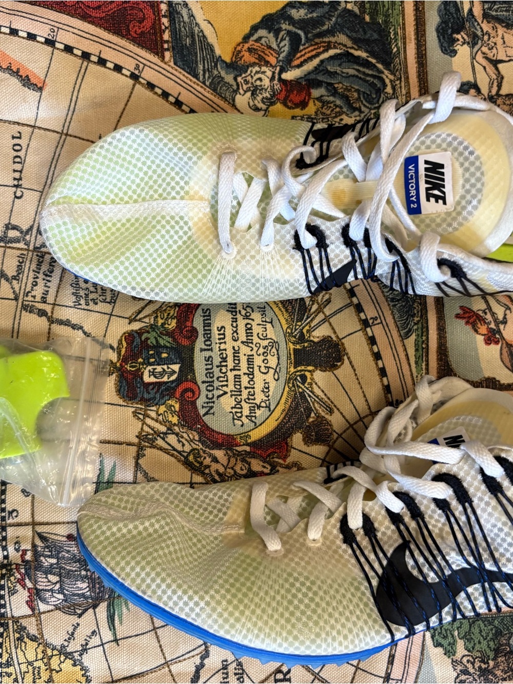 Nike White Sneakers with Neon Green Accents and Blue Outsole